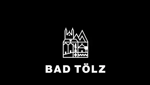 Weißes Bad Tölz Logo auf schwarzem Hintergrund mit grafischem Symbol und Schriftzug